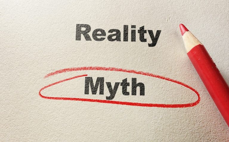 The word “Myth” circled in red beneath the word “Reality” beside a red pencil
