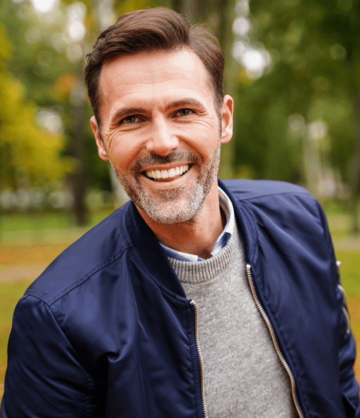 A man with a full head of hair smiling