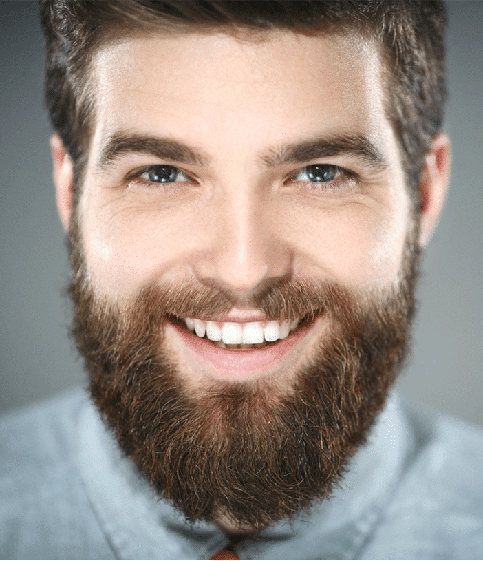 Smiling bearded man looking at the camera.